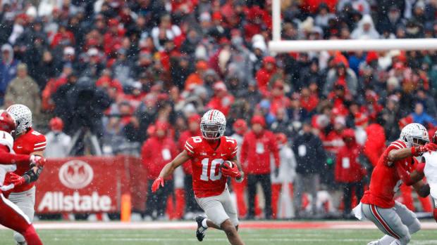 Xavier Johnson catches a screen pass and looks for a running lane.
